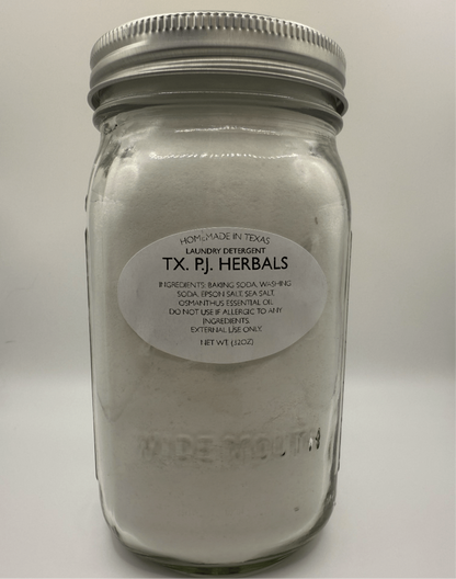 Jar of all-natural laundry detergent made with baking soda and essential oils in clear glass container
