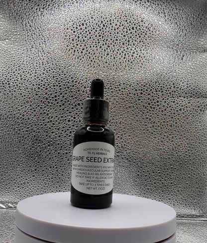 Bottle of all-natural grape seed tincture with fresh grapes and leaves